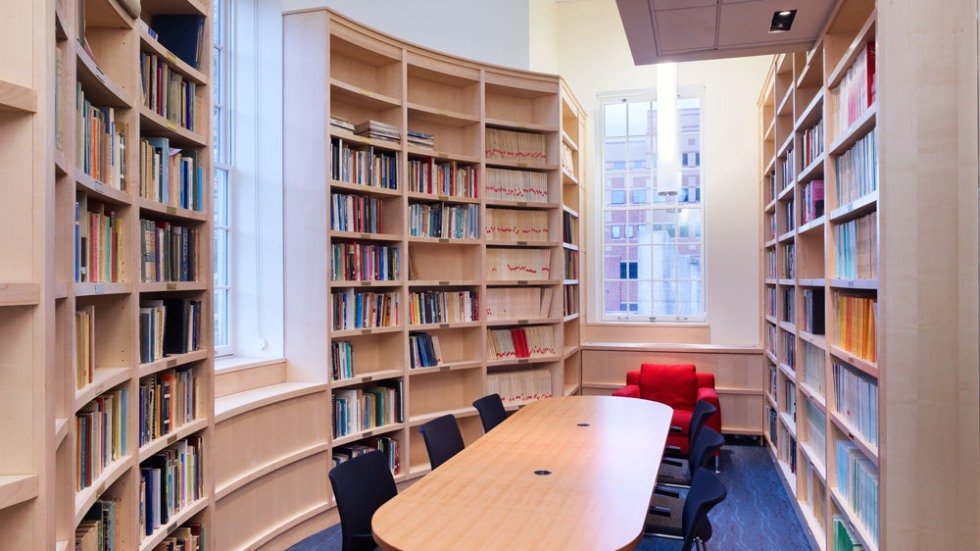 Table surrounded by bookshelves